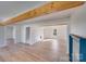 Open-concept living room with hardwood floors, decorative wood beam, and fireplace at 1200 Grace Ave, Kannapolis, NC 28083