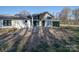 Modern style home with a covered patio and fenced backyard at 1207 Lakedell Dr, Charlotte, NC 28215