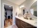 Bathroom featuring double sinks and a walk-in closet for storage at 1207 Lakedell Dr, Charlotte, NC 28215