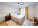 Cozy bedroom featuring hardwood floors, neutral tones, and an abundance of natural light at 1207 Lakedell Dr, Charlotte, NC 28215