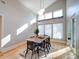 Sunlit dining area with wood floors, stylish lighting, and large windows at 1207 Lakedell Dr, Charlotte, NC 28215