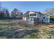 Bright home with dark trim showcasing clean lines, a privacy fence and covered patio at 1207 Lakedell Dr, Charlotte, NC 28215