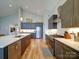 Modern kitchen with stainless steel appliances, hardwood floors, and a center island at 1207 Lakedell Dr, Charlotte, NC 28215