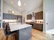 Contemporary kitchen featuring a center island, stainless appliances, and hardwood floors at 1207 Lakedell Dr, Charlotte, NC 28215