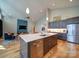 Modern kitchen with island, stainless steel appliances, and an open layout overlooking the stylish living area at 1207 Lakedell Dr, Charlotte, NC 28215