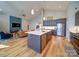 Open concept kitchen featuring stainless steel appliances, a center island, and hardwood floors at 1207 Lakedell Dr, Charlotte, NC 28215