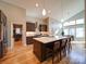 Well-lit kitchen featuring stainless steel appliances, island with seating, and hardwood floors at 1207 Lakedell Dr, Charlotte, NC 28215