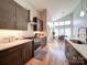 Modern kitchen with stainless steel appliances, lots of cabinets, and hardwood floors at 1207 Lakedell Dr, Charlotte, NC 28215