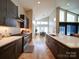 Modern kitchen with stainless steel appliances and dark brown cabinets at 1207 Lakedell Dr, Charlotte, NC 28215