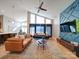 Spacious living room featuring high ceilings, natural light, modern decor, and a striking accent wall at 1207 Lakedell Dr, Charlotte, NC 28215
