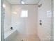 Modern shower with bench seating, glass enclosure, and subway tile at 1207 Lakedell Dr, Charlotte, NC 28215