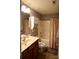 This bathroom features a shower/tub combo, vanity with cabinets, and neutral walls at 12123 Monteith Grove Dr, Huntersville, NC 28078