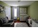 This Bedroom includes a crib, accent wall with pictures, and a gray glider at 12123 Monteith Grove Dr, Huntersville, NC 28078