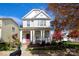Charming two-story home with a welcoming front porch and beautifully landscaped front yard at 12123 Monteith Grove Dr, Huntersville, NC 28078