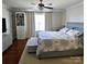 This main bedroom features a decorative wall, wood floors, and a gray upholstered bed and bench at 12123 Monteith Grove Dr, Huntersville, NC 28078