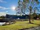 This pond area features a fountain, mature trees, and lush green grass at 12123 Monteith Grove Dr, Huntersville, NC 28078