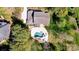 Aerial view of a gray home with a landscaped backyard featuring a modern pool and fire pit at 125 Arrow Point Ln, Davidson, NC 28036