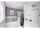 Relaxing bathroom with soaking tub, marble tile, shower with rain head, and vanity at 125 Arrow Point Ln, Davidson, NC 28036