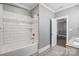 Bright bathroom with white subway tiles in the shower/tub and wood-look tile flooring at 125 Arrow Point Ln, Davidson, NC 28036
