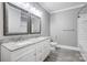 Bathroom featuring dual sinks with granite counters, wood-look tile, and tub with white subway tile at 125 Arrow Point Ln, Davidson, NC 28036