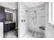 Bathroom with marble shower, dark cabinets, and marble tiling from shower to floor at 125 Arrow Point Ln, Davidson, NC 28036