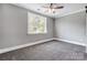 Cozy bedroom with soft carpet, fresh gray paint, and lots of natural light from large windows at 125 Arrow Point Ln, Davidson, NC 28036