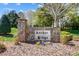 Stone community sign for Archer Ridge with beautiful landscaping and seasonal flowers at 125 Arrow Point Ln, Davidson, NC 28036