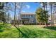 Traditional two-story home with manicured lawn, mature trees, and inviting covered entrance at 125 Arrow Point Ln, Davidson, NC 28036