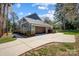 A beautiful view of this Craftsman-style home, including garage, driveway, and manicured landscaping at 125 Arrow Point Ln, Davidson, NC 28036