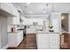 A modern kitchen boasts granite countertops, stainless appliances, white cabinetry, and a kitchen island at 125 Arrow Point Ln, Davidson, NC 28036