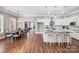 Open-concept kitchen features white cabinets, a large island with seating, and stainless steel appliances at 125 Arrow Point Ln, Davidson, NC 28036