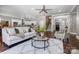 Spacious living area flows to the kitchen, featuring hardwood floors and neutral decor at 125 Arrow Point Ln, Davidson, NC 28036