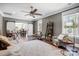 Living area with sliding barn doors, decorative shelving, a ceiling fan, and natural lighting at 125 Arrow Point Ln, Davidson, NC 28036