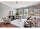 Bright living room with large windows, hardwood floors, and cozy seating area with modern furnishings at 125 Arrow Point Ln, Davidson, NC 28036