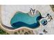 Overhead view of an inground pool with spa and tanning ledge, framed by travertine and concrete decking at 125 Arrow Point Ln, Davidson, NC 28036
