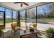 Relaxing screened porch with comfortable wicker chairs and a view of the beautiful pool area at 125 Arrow Point Ln, Davidson, NC 28036
