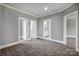 Spacious upstairs landing featuring gray carpeting and white trim with neutral gray paint at 125 Arrow Point Ln, Davidson, NC 28036