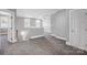 Upstairs landing featuring gray carpeting, multiple doors and windows with neutral gray paint at 125 Arrow Point Ln, Davidson, NC 28036