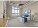 Bedroom featuring neutral walls, a large picture window with water view, and tray ceilings, enhancing the spaciousness at 134 Larkhaven Ln, Mooresville, NC 28117