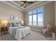 Cozy bedroom with large window view, tray ceilings, and soft neutral colors, creating a serene atmosphere at 134 Larkhaven Ln, Mooresville, NC 28117