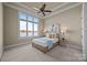 Cozy bedroom featuring a ceiling fan, and a large window with a gorgeous lake view at 134 Larkhaven Ln, Mooresville, NC 28117