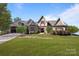 Charming exterior with stone accents and meticulously manicured lawn, exuding timeless elegance at 134 Larkhaven Ln, Mooresville, NC 28117