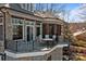 Exterior elevation showcasing a stone patio and a lake view at 134 Larkhaven Ln, Mooresville, NC 28117