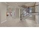 Grand foyer featuring a staircase with decorative iron railings, tile floors, and elegant archways at 134 Larkhaven Ln, Mooresville, NC 28117
