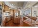 Spacious kitchen featuring hardwood floors, granite countertops, a wooden island, and modern appliances at 134 Larkhaven Ln, Mooresville, NC 28117