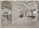 Open concept living room with lake views, coffered ceilings, hardwood floors, and a modern kitchen at 134 Larkhaven Ln, Mooresville, NC 28117