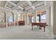 Spacious living room featuring coffered ceilings, hardwood floors, recessed lighting and French doors with lake views at 134 Larkhaven Ln, Mooresville, NC 28117