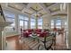 Beautiful living room with coffered ceilings and many large windows with lake views at 134 Larkhaven Ln, Mooresville, NC 28117