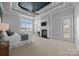 Large bedroom with fireplace, tray ceilings, carpeted floors, and lots of natural light at 134 Larkhaven Ln, Mooresville, NC 28117