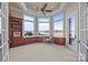 Bright office space with lake views, built-in wood shelving and cabinets, and a comfortable seating area at 134 Larkhaven Ln, Mooresville, NC 28117